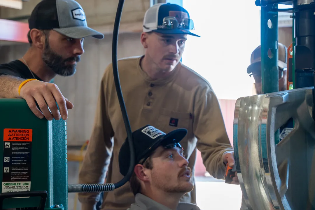 Technicians servicing refrigeration equipment