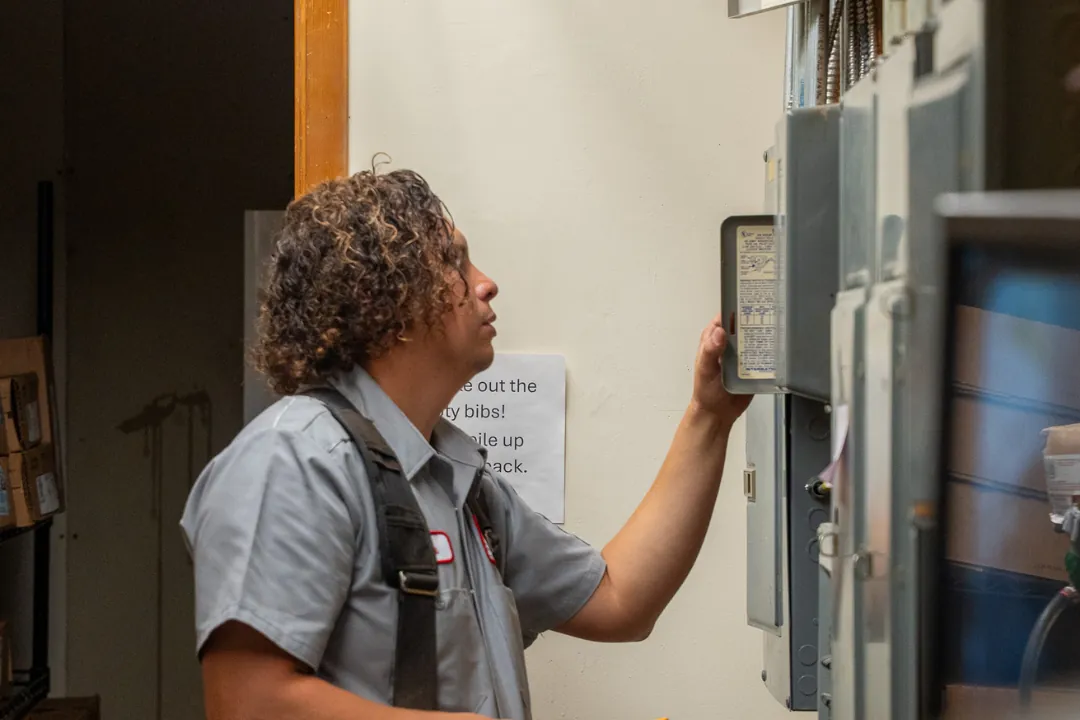 Technician working inside a customer's building