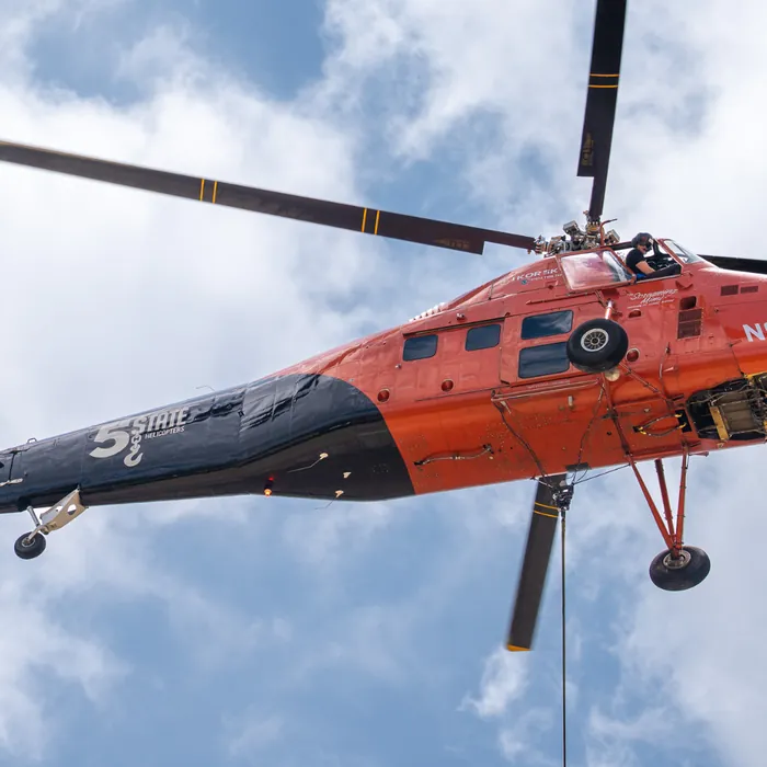 Sikorsky sky crane setting equipment on a commercial roof